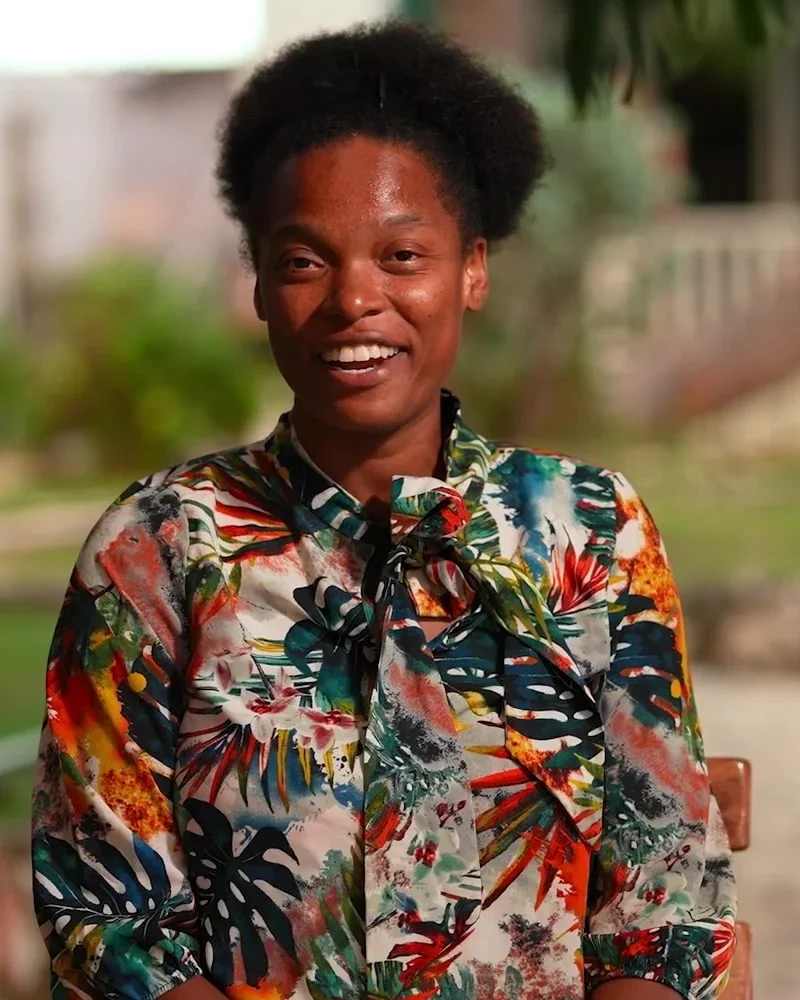 Tina, Resort Manager at Home Sweet Home, smiling in the garden